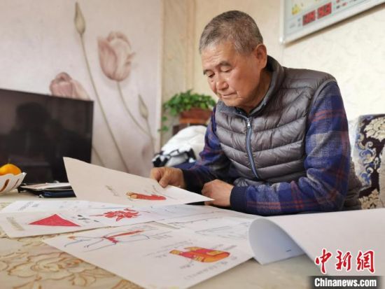 圖為陸鵬飛向記者展示多年帶隊(duì)的手寫筆記?！堟?攝