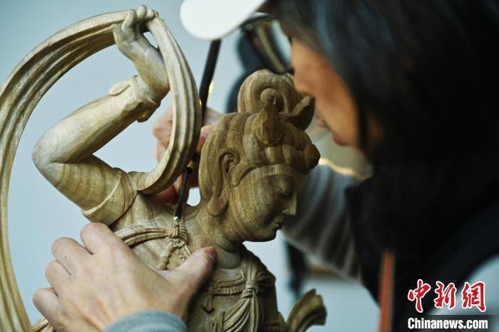 圖為季茂杰進行敦煌元素的木雕創(chuàng)作。李亞龍 攝</p>
<p>