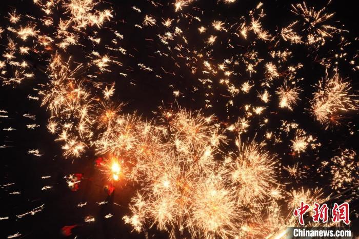 灼熱的鐵水在空中迸散。在空中形成“鐵花火雨”的景象，似天女散花，似群星漫天，如夢如幻，美不勝收。侯奇志 攝</p>
<p>