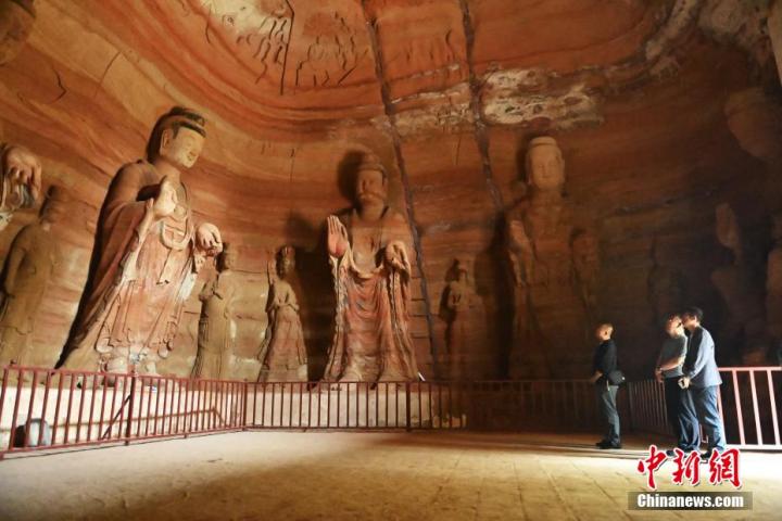 7月15日，游人參觀甘肅省平?jīng)鍪袥艽h百里石窟長廊中的南石窟寺1號窟。百里石窟長廊位于涇川縣境內(nèi)，由512個石窟、5眼窟中石井組成，現(xiàn)存王母宮石窟、鳳凰山石窟、南石窟寺、丈八寺石窟、羅漢洞石窟、太山寺石窟等規(guī)模較大的石窟群，還有數(shù)量眾多的小石窟群。南石窟寺開鑿于北魏永平三年，其中1號窟屬于大型七佛窟，七佛高達(dá)6米。中新社記者 李亞龍 攝